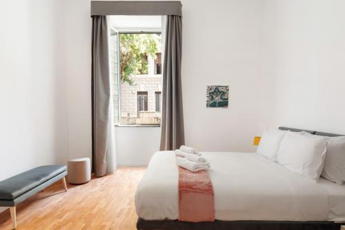 a bedroom with a white bed and a window at Rome Nice Stays in Rome