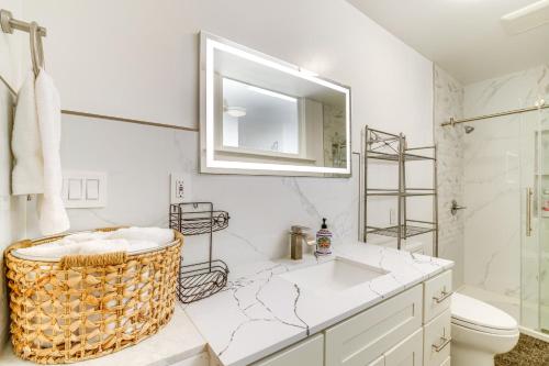 a bathroom with a sink and a toilet and a mirror at Montara Apartment with Yard Near Beaches in Montara