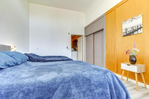 a bedroom with a blue comforter on a bed at Montara Apartment with Yard Near Beaches in Montara