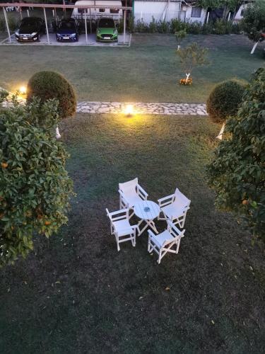 a group of chairs and a table in a yard at Villa Adamidis in Paralía Skotínis