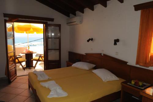 a bedroom with a bed and a view of the ocean at Despina Studios in Kokkari