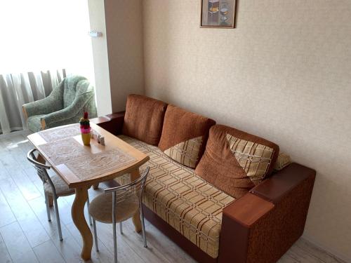 a living room with a couch and a table at APARTMENT PREMIUM VIP in Berdychiv