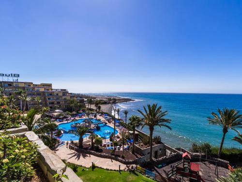 a view of the beach and the ocean from a resort at Apartamentos BlueBay Beach Club in San Agustin