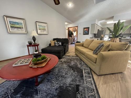 a living room with a couch and a table at 37CPD, Two bedroom, two bath log-sided condo with forest view condo in Mount Ida