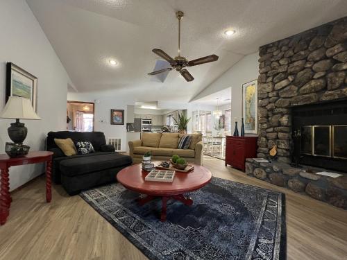 a living room with a couch and a fireplace at 37CPD, Two bedroom, two bath log-sided condo with forest view condo in Mount Ida