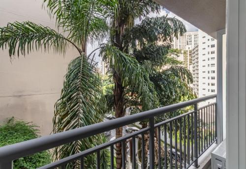 a balcony with two palm trees in a city at 360 Ascent Paulista in Sao Paulo