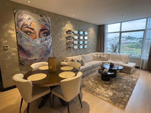 a living room with a couch and a table at Tanger Hilton Penthouse 15 in Tangier