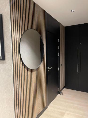a round mirror on a wall with a door at Tanger Hilton Penthouse 15 in Tangier