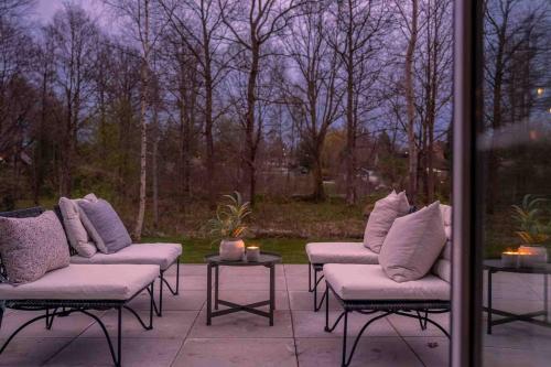 a group of couches sitting on a patio at The cheerful nordic homes in Perstorp