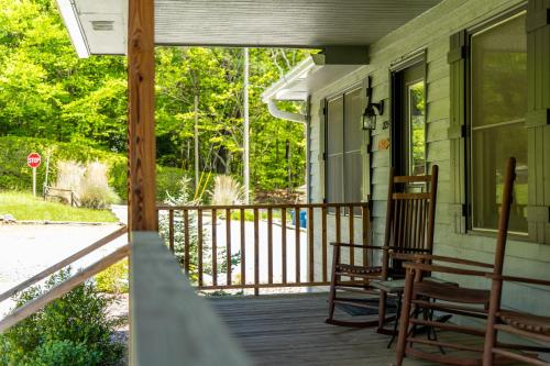 a porch with two chairs and a stop sign at Blowing Rock Inn in Blowing Rock