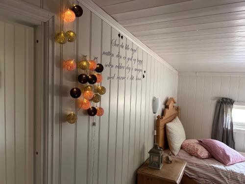 a bedroom with a bed and some decorations on the wall at Gemütliches Blockhaus in Nornäs