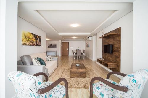 a living room with a couch and a table at Apartamentos Monte Felice Stay in Gramado