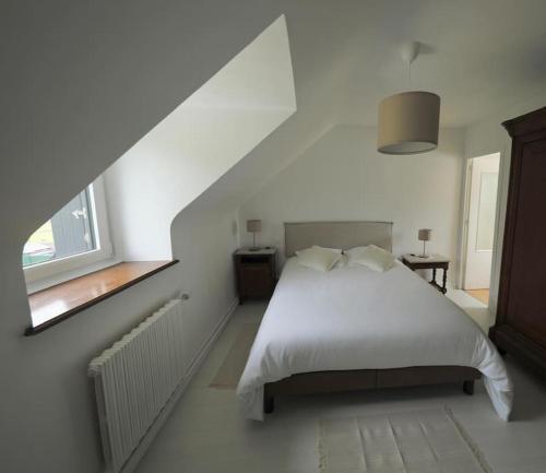 une chambre avec un lit blanc et une fenêtre dans l'établissement Ti Ar Familhou classée 3 étoiles, à Paimpol
