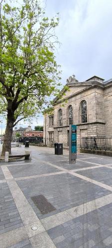 an old building with a tree in front of it at Kilmainham Homestay, Large Double Room in Dublin
