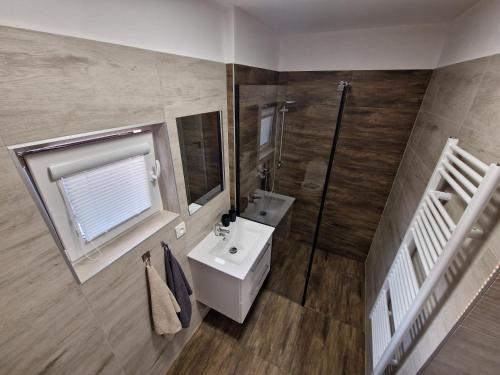 a bathroom with a sink and a mirror at Apartmán Anežka 2 in Jičín