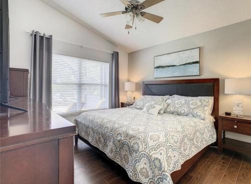 a bedroom with a bed and a ceiling fan at Updated Private Pool Villa - Southern Dunes in Haines City