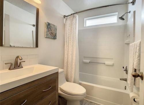 a bathroom with a toilet and a sink and a shower at Updated Private Pool Villa - Southern Dunes in Haines City