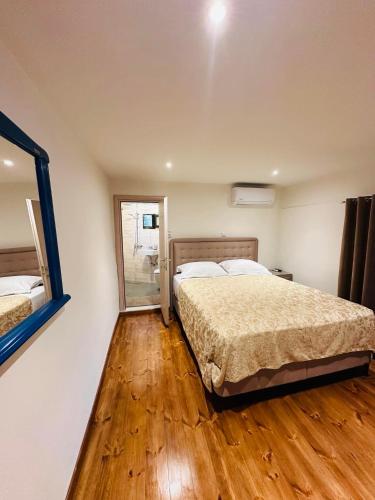 a bedroom with two beds and a mirror at Villa Antoaneta in Panagia