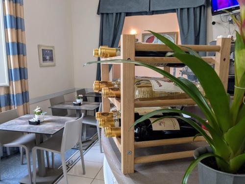 a room with tables and a bunk bed with wine bottles at Hotel Soggiorno Athena in Pisa