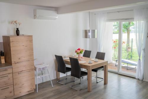 a dining room with a wooden table and chairs at Apartment Swim and Relax in Moravske Toplice