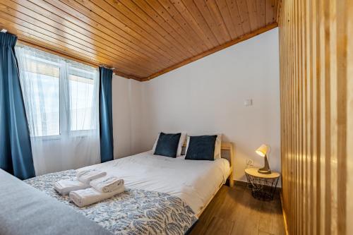 a bedroom with a bed with two towels on it at Wake up with the Sea Breeze- House with pool AP1 in Lavra
