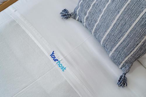 a close up of a bed with a white mattress with a pillow at Wake up with the Sea Breeze- House with pool AP1 in Lavra