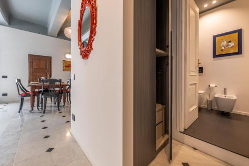 a hallway with a dining room with a table at Giada Home Luxury in Genova City Centre in Genova