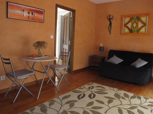 un salon avec une table et un canapé dans l'établissement La Mandarine, à Colomars