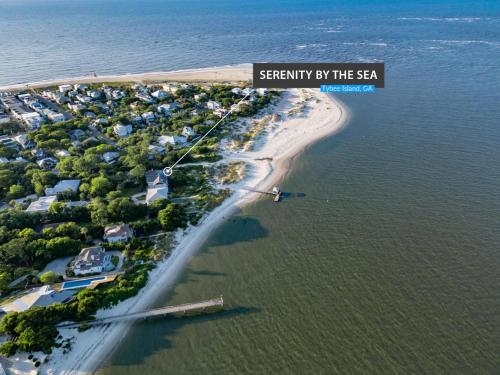 a view of a beach with a sign that reads security by the sea at Serenity at the Sea in Tybee Island