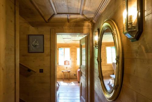 a hallway of a house with a mirror on the wall at Gstaad - Great Luxurious Farmhouse in Kalberhöni