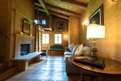 a living room with a couch and a table at Gstaad - Great Luxurious Farmhouse in Kalberhöni