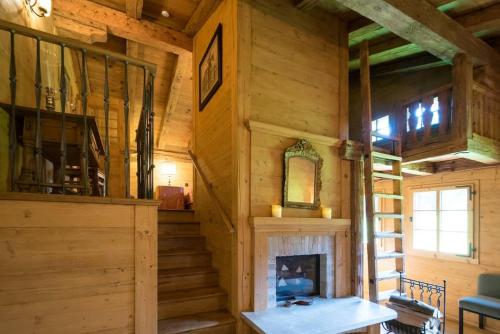 a room with a fireplace in a log cabin at Gstaad - Great Luxurious Farmhouse in Kalberhöni
