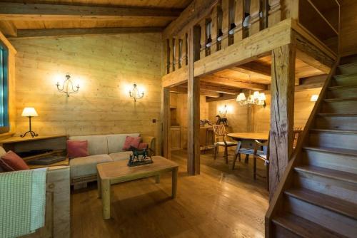 a living room with a couch and a table at Gstaad - Great Luxurious Farmhouse in Kalberhöni