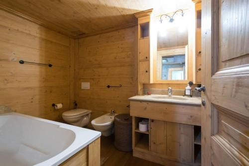 a bathroom with a toilet and a sink and a tub at Gstaad - Great Luxurious Farmhouse in Kalberhöni
