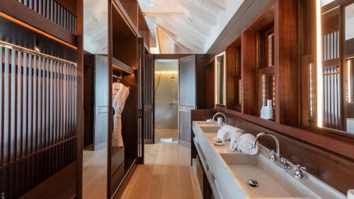 a bathroom with two sinks and a walk in shower at Spacious Villa with True Architectural Gem in Toiny