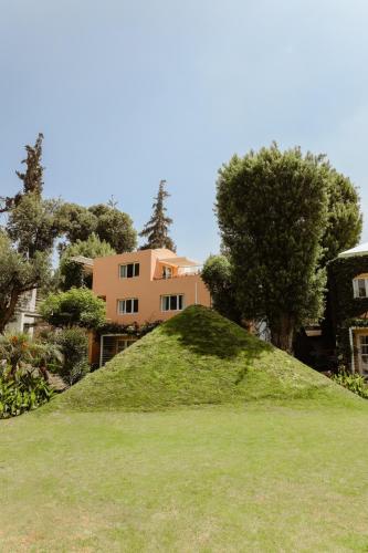 a mound of grass in front of a house at La Posada del Puente in Arequipa