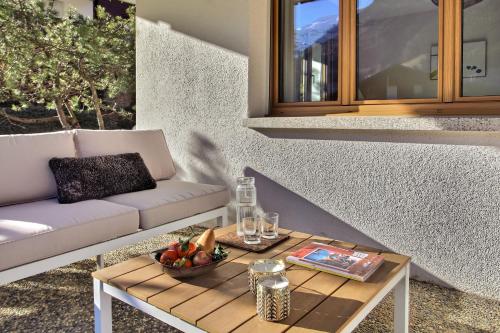 a coffee table with a bowl of fruit on a patio at Val Air E53 Terrace & Relaxation in Champéry
