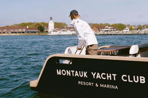 a man standing on the front of a boat at Montauk Yacht Club in Montauk