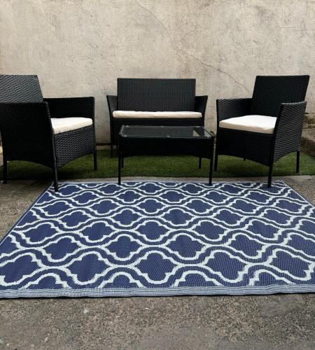 a group of three chairs and a rug on the ground at Deluxe Inn Gateshead in Gateshead