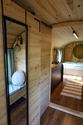 a small room in a tiny house with a mirror at Oaza Święty Spokój - domek z balią i jacuzzi in Rząśnik