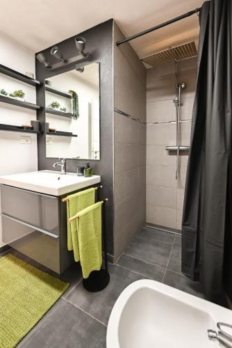a bathroom with a sink and a shower at Apartma Nemo in Izola