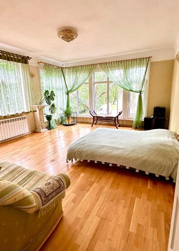 a bedroom with a large bed and a wooden floor at fantasy park in Ventspils