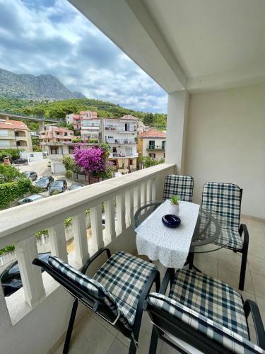 a balcony with a table and chairs and a view at Villa Norah in Podgora