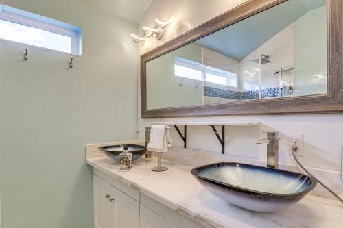 a bathroom with a sink and a large mirror at Skydance Cabin in Polson, 5 Mi to Flathead Lake! in Polson