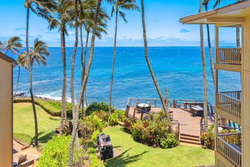 a view of the ocean from the balcony of a house at Poipu Palms 302 in Koloa