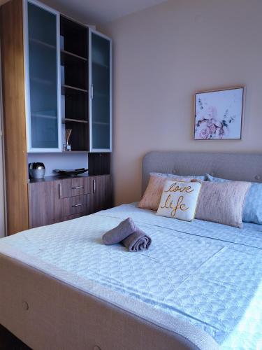 a bedroom with a large bed with a pillow on it at The View Apartment in Plovdiv