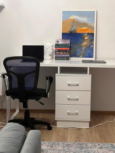an office with a desk with a laptop and a chair at Cozy Apartment in Pogradec, near Ohrid Lake in Pogradec