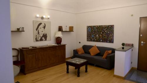 a living room with a couch and a table at La Casa di Anita in Asti
