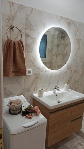 a bathroom with a sink and a mirror at Coolio's home in Ágios Rókkos