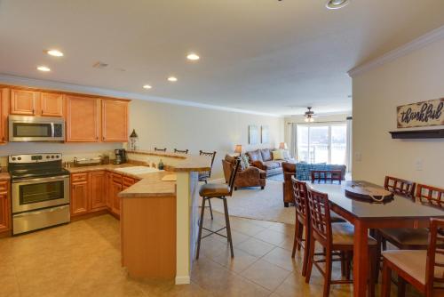 a kitchen and living room with a table and chairs at Lake Views and Pool Access Osage Beach Condo in Osage Beach